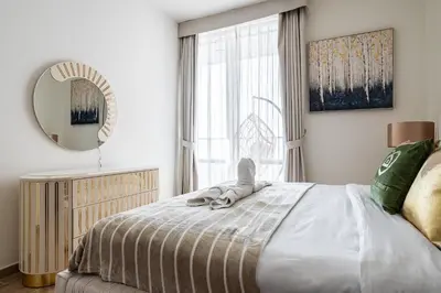 a bedroom with a bed with a mirror and a window at Luxury 2Br Apt Stunning Views in Amna Tower by Simply Comfort in Dubai