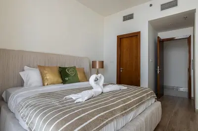 a bedroom with a bed with a towel animal on it at Luxury 2Br Apt Stunning Views in Amna Tower by Simply Comfort in Dubai