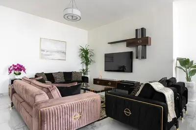 a living room with two couches and a tv at Luxury 2Br Apt Stunning Views in Amna Tower by Simply Comfort in Dubai