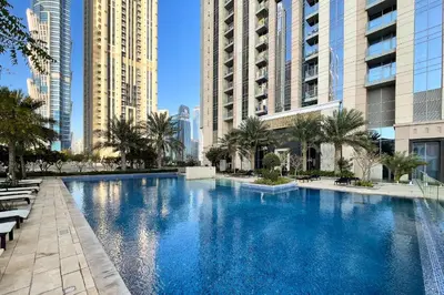 a large swimming pool in a city with tall buildings at Luxury 2Br Apt Stunning Views in Amna Tower by Simply Comfort in Dubai