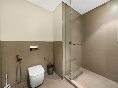 a bathroom with a toilet and a shower at Grande Signature 2 Bedroom Apartments I Persian Gulf Views I Free Parking, Gym, Pool, Wi-Fi & PS5 I by Skyline Serenity in Dubai