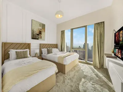 a hotel room with two beds and a tv at Grande Signature 2 Bedroom Apartments I Persian Gulf Views I Free Parking, Gym, Pool, Wi-Fi & PS5 I by Skyline Serenity in Dubai
