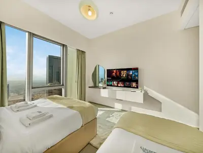 a bedroom with two beds and a large window at Grande Signature 2 Bedroom Apartments I Persian Gulf Views I Free Parking, Gym, Pool, Wi-Fi & PS5 I by Skyline Serenity in Dubai