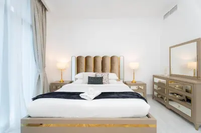 a bedroom with a large white bed and a mirror at GuestReady - Fabulous home with Marina Canal views in Dubai
