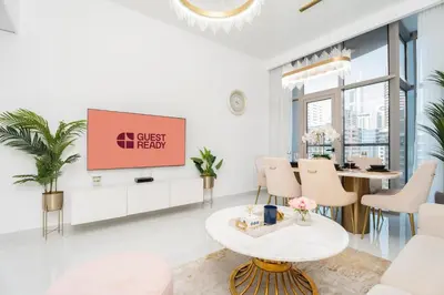 a living room with a table and a tv at GuestReady - Fabulous home with Marina Canal views in Dubai