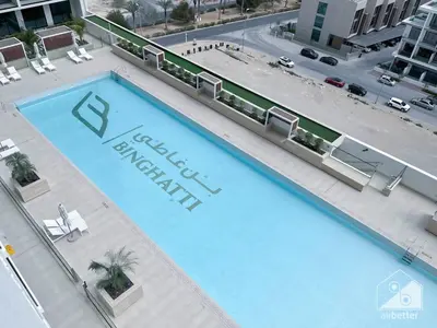 an overhead view of a large blue swimming pool at Luxury & Comfort at Binghatti Amber with Balcony in Dubai