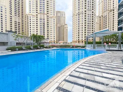 a large blue swimming pool in a city with tall buildings at Luxury 2B Apt with Full Marina Views - Delphine in Dubai