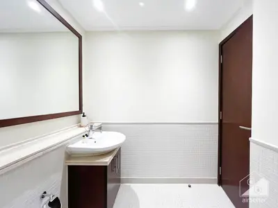 a white bathroom with a sink and a mirror at Luxury 2B Apt with Full Marina Views - Delphine in Dubai