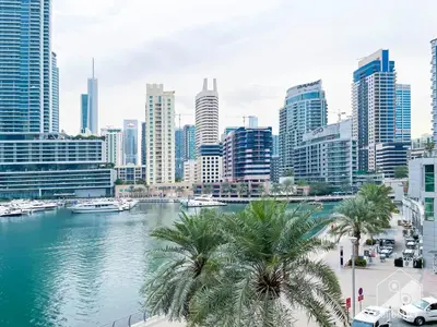 a city skyline with a river and palm trees at Luxury 2B Apt with Full Marina Views - Delphine in Dubai