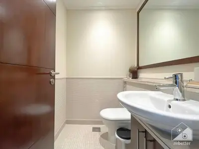 a bathroom with a sink and a toilet and a mirror at Luxury 2B Apt with Full Marina Views - Delphine in Dubai