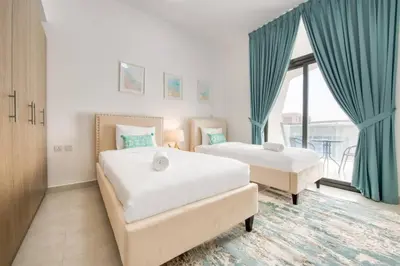 a bedroom with two beds and a large window at Serene 2 Bedrooms Apartment in Dubai