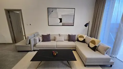 a living room with a couch and a table at Stella Maris Marine view in Dubai
