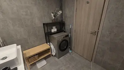 a bathroom with a washing machine and a sink at Stella Maris Marine view in Dubai