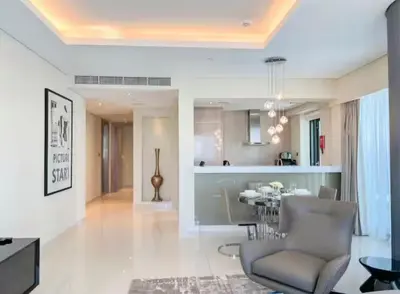 a dining room and living room with a dining table at Luxury 2 Bedroom Apartment in Downtown in Dubai