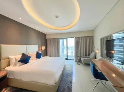 a hotel room with a large bed and a flat screen tv at Luxury 2 Bedroom Apartment in Downtown in Dubai