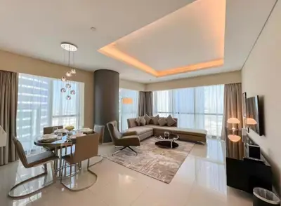 a living room with a couch and a table at Luxury 2 Bedroom Apartment in Downtown in Dubai
