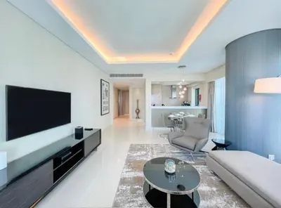 a living room with a large television and a couch at Luxury 2 Bedroom Apartment in Downtown in Dubai