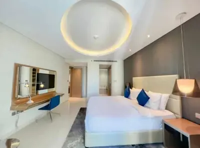 a large bedroom with a large bed and a television at Luxury 2 Bedroom Apartment in Downtown in Dubai