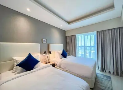 a hotel room with two beds and a window at Luxury 2 Bedroom Apartment in Downtown in Dubai