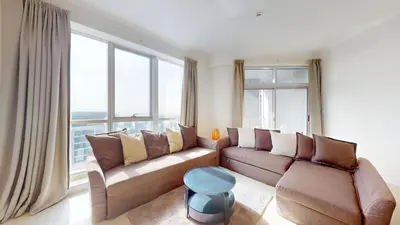 a living room with a couch and large windows at Vacationer I Sophisticated 2 Bedroom Apartment I High Floor I Scenic Skyline Escape I Torch Tower - Marina in Dubai