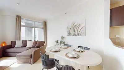 a living room with a table and a couch at Vacationer I Sophisticated 2 Bedroom Apartment I High Floor I Scenic Skyline Escape I Torch Tower - Marina in Dubai
