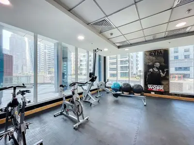 a gym with bikes and exercise equipment in a building at Vacationer I Sophisticated 2 Bedroom Apartment I High Floor I Scenic Skyline Escape I Torch Tower - Marina in Dubai
