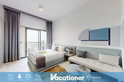 a hotel room with a bed and a couch at Mag Eye - Cozy Studio in Meydan in Dubai