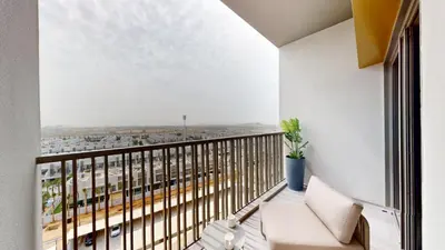 a balcony with a view of a city at Mag Eye - Cozy Studio in Meydan in Dubai