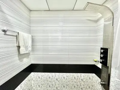 a bathroom with a shower with a black and white at Homes2Retreat - Resort Living Close to Miracle Garden in Dubai