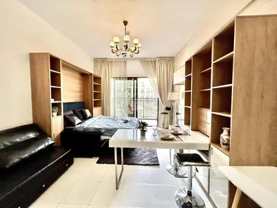 a room with a desk and a bed in a room at Homes2Retreat - Resort Living Close to Miracle Garden in Dubai
