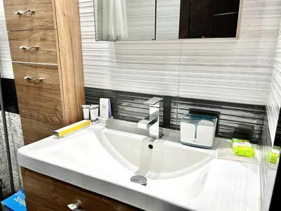 a white sink in a bathroom with a mirror at Homes2Retreat - Resort Living Close to Miracle Garden in Dubai