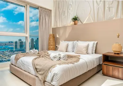 a bedroom with a large bed with a large window at Pristine 2BR Apt in Dubai! JBR, Marina & Sea View in Dubai