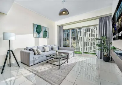 a living room with a couch and a table at Pristine 2BR Apt in Dubai! JBR, Marina & Sea View in Dubai