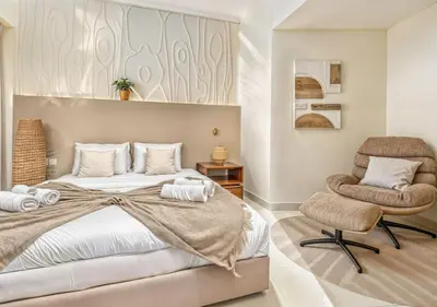 a bedroom with a bed and a chair at Pristine 2BR Apt in Dubai! JBR, Marina & Sea View in Dubai