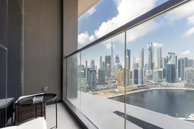 a balcony with a view of a city skyline at Waves - Elegant Waterfront Living in Dubai's Business Bay in Dubai