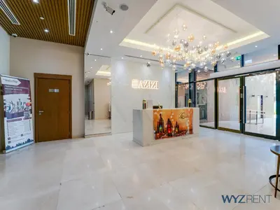 a lobby of a building with a chandelier at Winter Bliss Studio Azizi Riviera 9 Pool View in Dubai