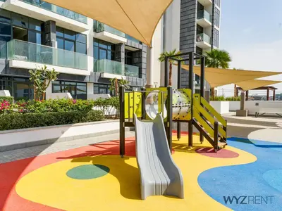 a playground in front of a building at Winter Bliss Studio Azizi Riviera 9 Pool View in Dubai