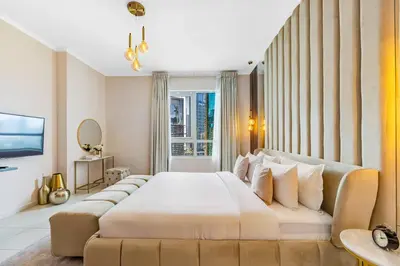 a bedroom with a large bed and a large window at Durrani Homes - Modern Living 3br with Burj Khalifa and Fountain View - third room without partition in Dubai