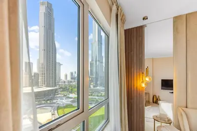 a room with a window with a view of a city at Durrani Homes - Modern Living 3br with Burj Khalifa and Fountain View - third room without partition in Dubai
