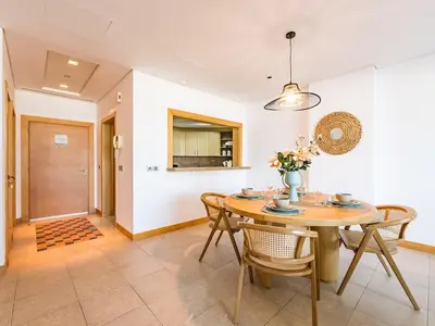 a dining room with a table and chairs at Beachfront Sea View 1BR-Jash Falqa- Palm Jumeirah in Dubai