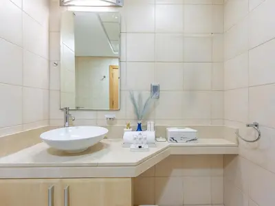 a bathroom with a sink and a mirror at Beachfront Sea View 1BR-Jash Falqa- Palm Jumeirah in Dubai
