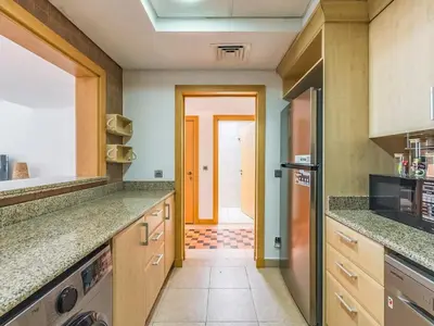 a kitchen with granite counter tops and a door at Beachfront Sea View 1BR-Jash Falqa- Palm Jumeirah in Dubai