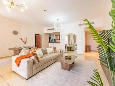 a living room with a couch and a table at The Cozy Cove 1BR at Rimal 4,JBR in Dubai