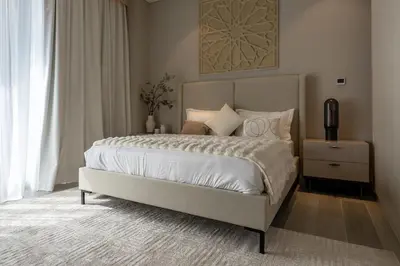 a bedroom with a large bed with white sheets and pillows at Gracious 1BR in Condor Marina Star, Dubai Marina in Dubai