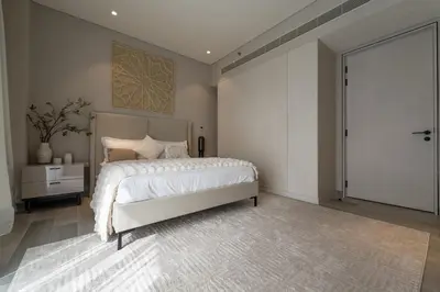 a bedroom with a large bed and a sliding glass door at Gracious 1BR in Condor Marina Star, Dubai Marina in Dubai