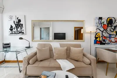 a living room with a couch and a mirror at Iris Blue, Dubai Marina - Mint Stay in Dubai