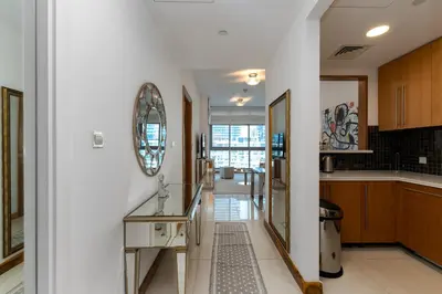 a kitchen with white walls and a mirror on the wall at Iris Blue, Dubai Marina - Mint Stay in Dubai