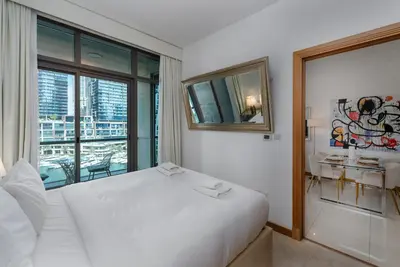 a bedroom with a large white bed and a window at Iris Blue, Dubai Marina - Mint Stay in Dubai