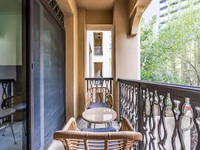 a patio with two chairs and a table on a balcony at Cozy 1BR- Yansoon 4- Heart of Downtown Dubai in Dubai