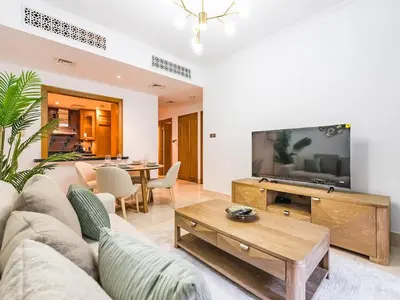 a living room with a couch and a tv at Cozy 1BR- Yansoon 4- Heart of Downtown Dubai in Dubai